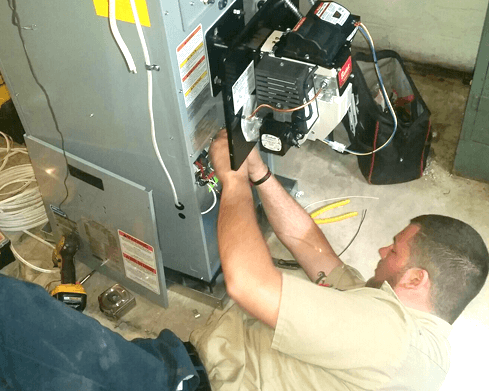 Tech doing a heating repair