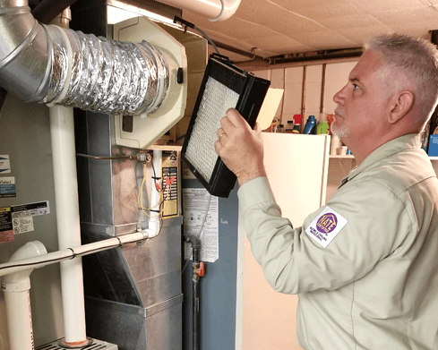 Techs installing a whole home humidifer